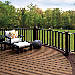 Large backyard deck designed with Trex Signature® railing in Charcoal Black and Vintage Lantern. 