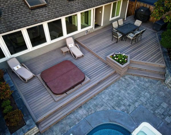 Rocky Harbour field and bordering, risers, and cladding, lighting package. This backyard space screams elegance, while maintaining functional flow to the pool deck.