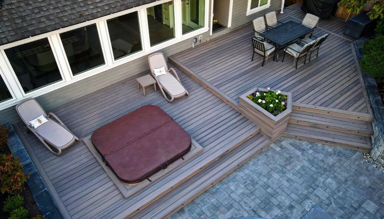 Rocky Harbour field and bordering, risers, and cladding, lighting package. This backyard space screams elegance, while maintaining functional flow to the pool deck.