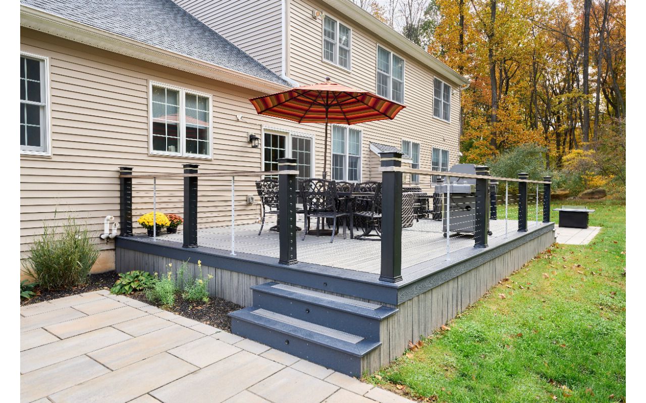 Timeless beauty meets low-maintenance convenience with this Trex deck, offering a stylish and durable outdoor space for years of enjoyment