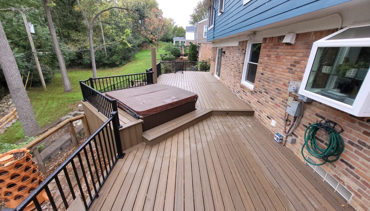 Trex deck and bench surrounding a inserted hot tub
