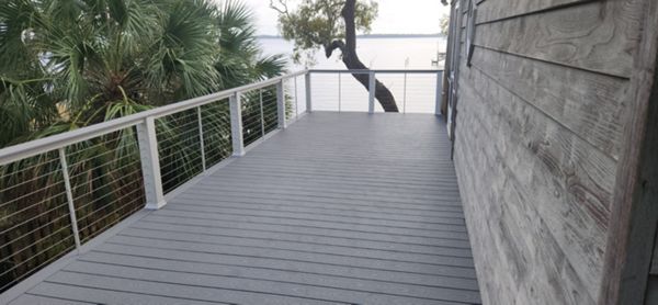 Pebble Grey deck 2 stories up at the coast with stainless cable railing