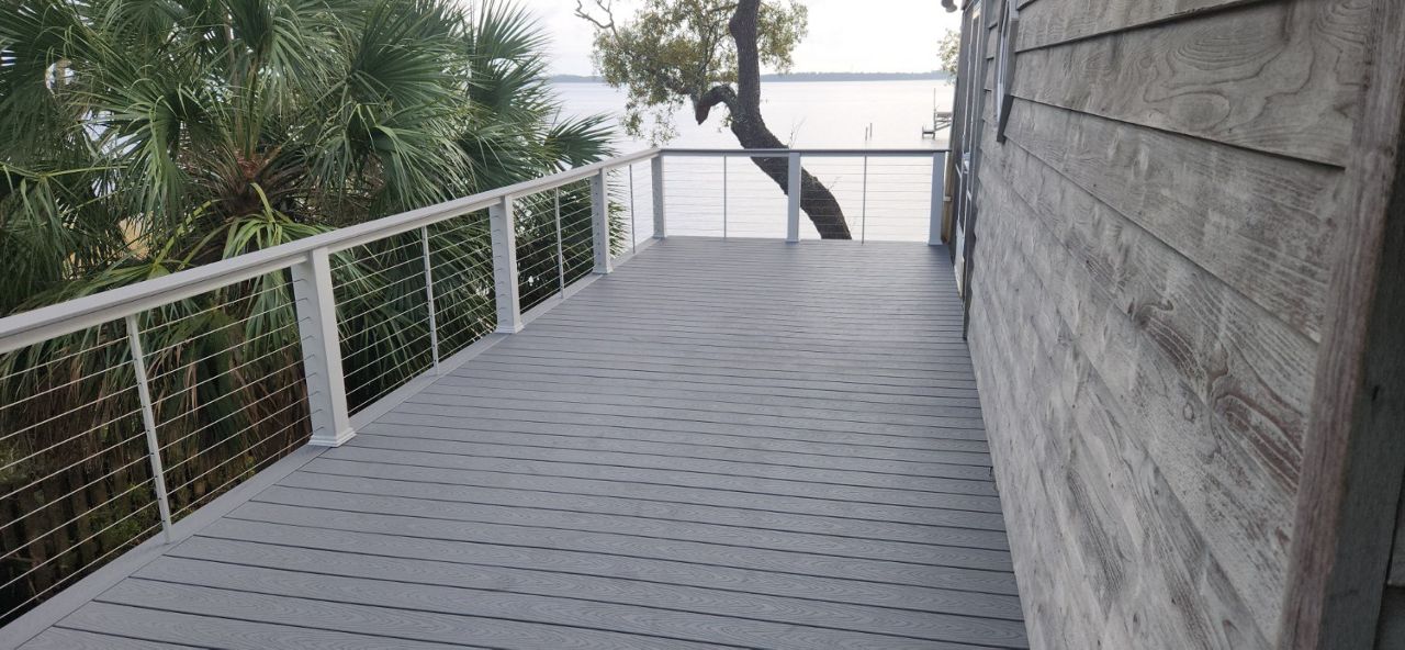 Pebble Grey deck 2 stories up at the coast with stainless cable railing