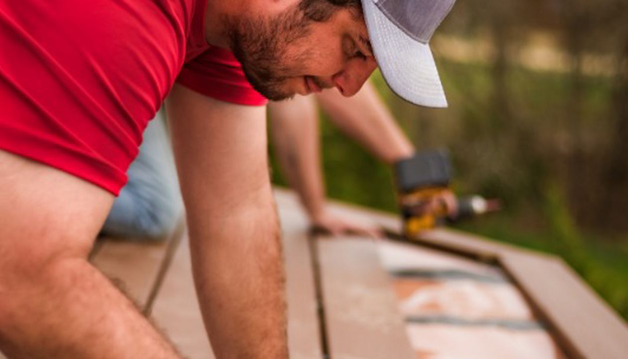 Installing boards over the Under-Deck Drainage System