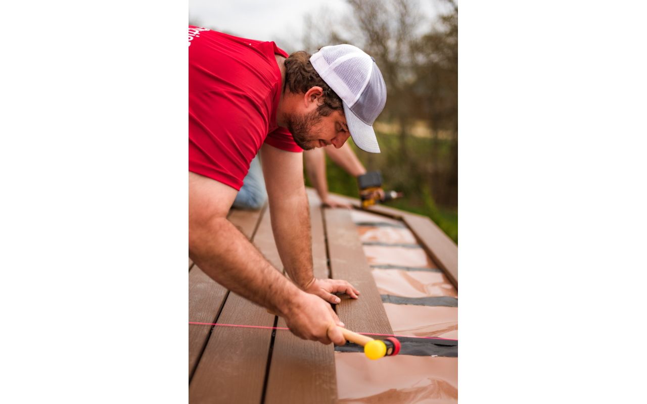 Installing boards over the Under-Deck Drainage System