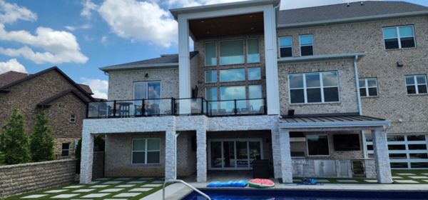 Trex Lineage decking with Trex Glass handrails above outdoor living space by the pool