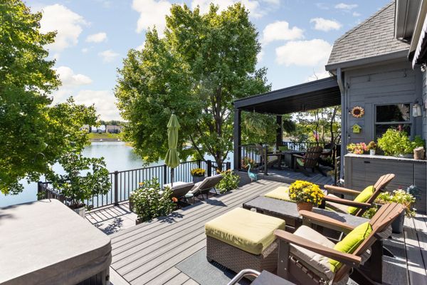 Trex Deck in Island Mist and Signature Rail. Waterproof shade structure with ceiling fan.