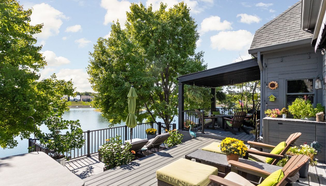 Trex Deck in Island Mist and Signature Rail. Waterproof shade structure with ceiling fan.