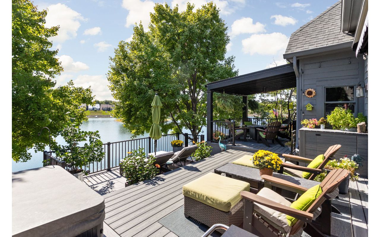 Trex Deck in Island Mist and Signature Rail. Waterproof shade structure with ceiling fan.