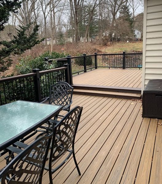 Trex Transcend Havana Gold framed by Trex Transcend Lava Rock with Trex Transcend Vintage Lantern Railing
