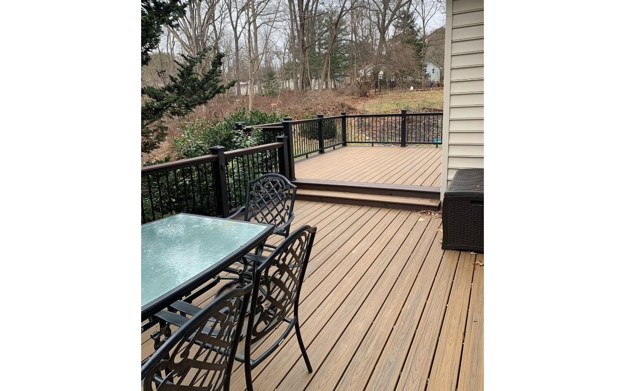 Trex Transcend Havana Gold framed by Trex Transcend Lava Rock with Trex Transcend Vintage Lantern Railing