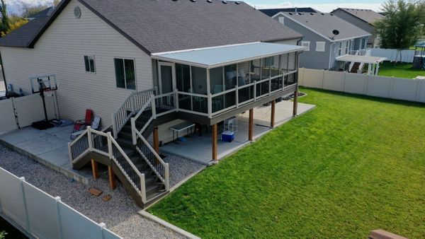 Trex® Coastal Bluff deck featuring a screen room, Trex® Joist Tape for lasting protection, and a custom doggy door — built for comfort, durability, and everyday living.