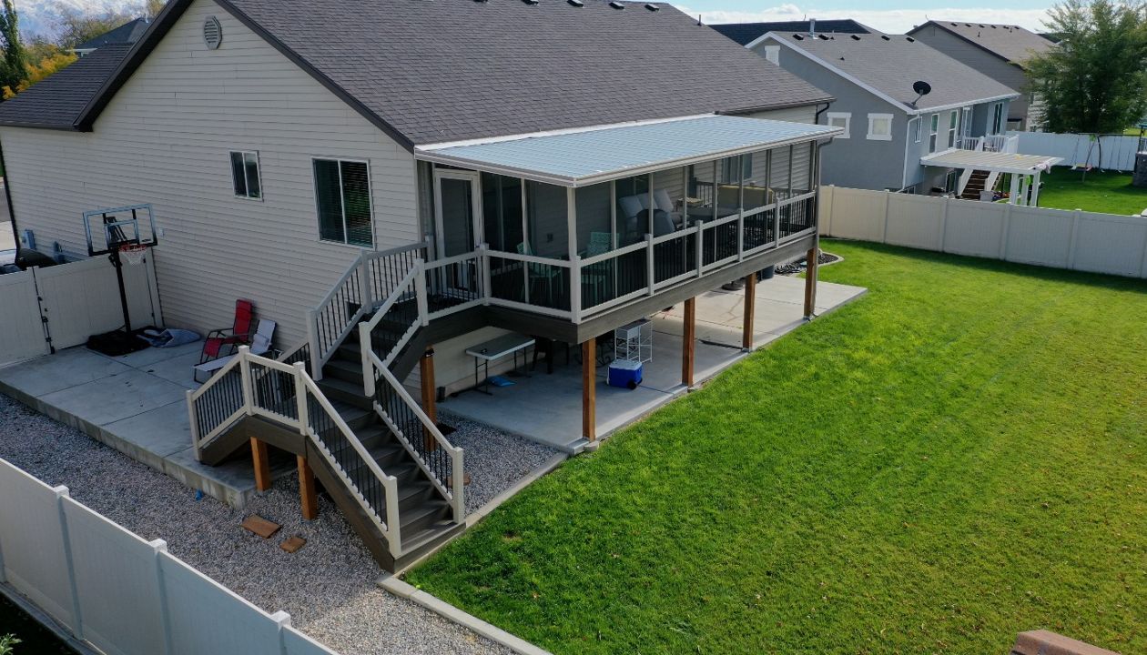 Trex® Coastal Bluff deck featuring a screen room, Trex® Joist Tape for lasting protection, and a custom doggy door — built for comfort, durability, and everyday living.