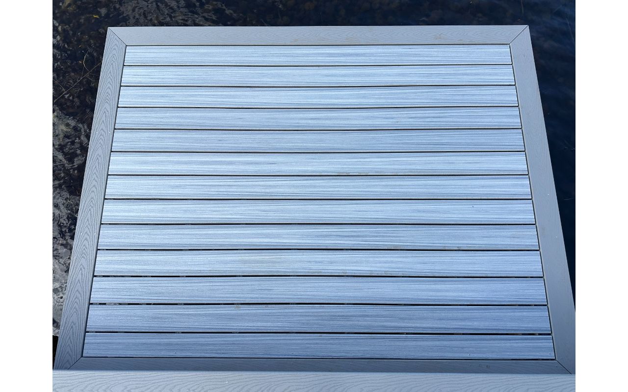 The Kailua deck features Foggy Wharf decking with a Pebble Grey picture frame border and custom steps, designed for a sleek and modern look.