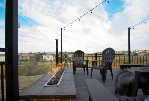 Castle Rock, CO Trex Transcend deck in Island Mist with iron rail, custom fire pit with fire glass behind
