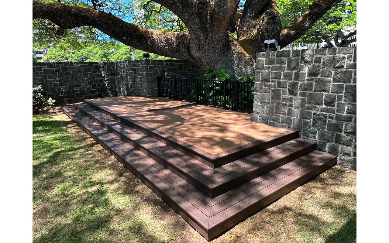 The deck is made with Trex Transcend® Tiki Torch decking, Lava Rock trim, and black Trex Signature® railing, designed for a seamless and elegant finish.