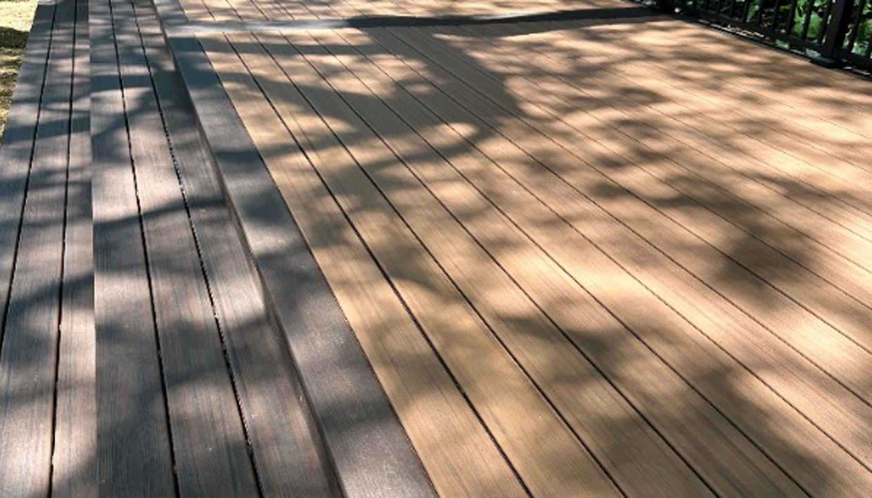 The deck is made with Trex Transcend® Tiki Torch decking, Lava Rock trim, and black Trex Signature® railing, designed for a seamless and elegant finish.