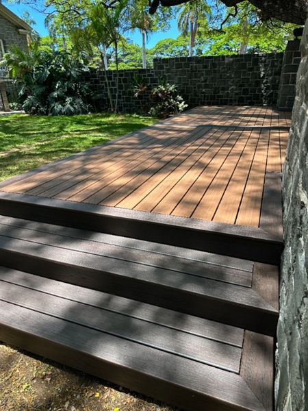 The deck is made with Trex Transcend® Tiki Torch decking, Lava Rock trim, and black Trex Signature® railing, designed for a seamless and elegant finish.