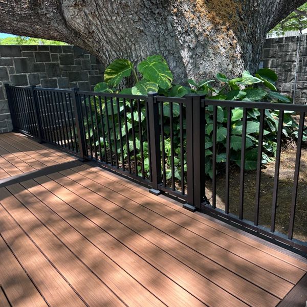 The deck is made with Trex Transcend® Tiki Torch decking, Lava Rock trim, and black Trex Signature® railing, designed for a seamless and elegant finish.