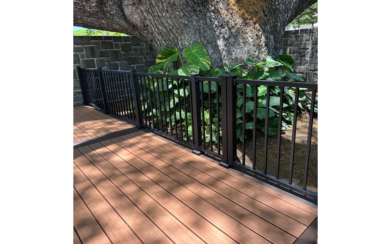 The deck is made with Trex Transcend® Tiki Torch decking, Lava Rock trim, and black Trex Signature® railing, designed for a seamless and elegant finish.