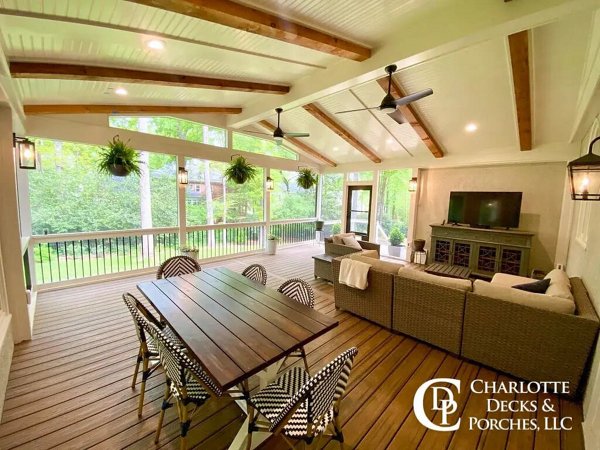 Screened in porch with decking in Trex Foggy Wharf with two Adirondack chairs looking out on the yard