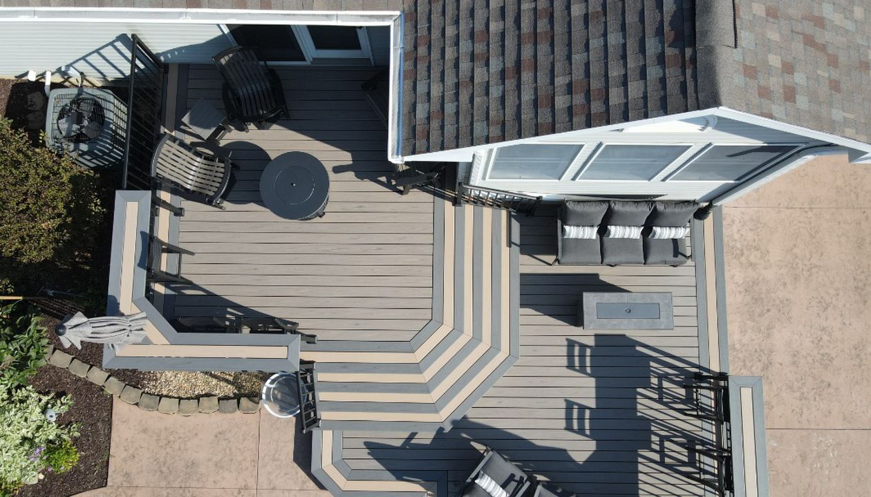 Trex Transcend Lineage Biscayne decking with Caramel & Island Mist accents.  Custom Trex bartops