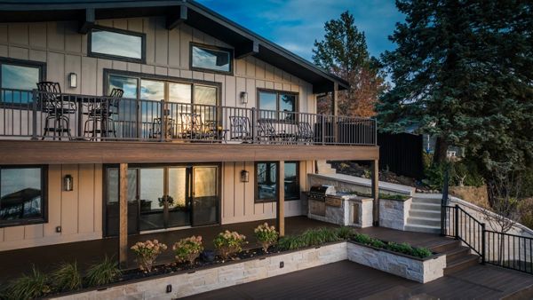 Elevated composite deck with aluminum railing and a custom outdoor kitchen designed for entertaining and sunset views.