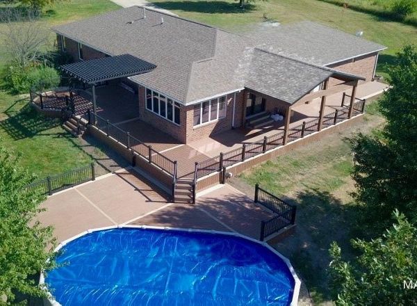 Multi level Trex deck with covered porch and pergola in Bloomington IL.
