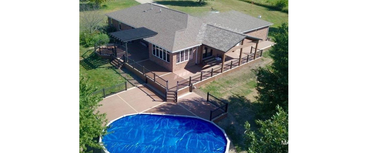 Multi level Trex deck with covered porch and pergola in Bloomington IL.