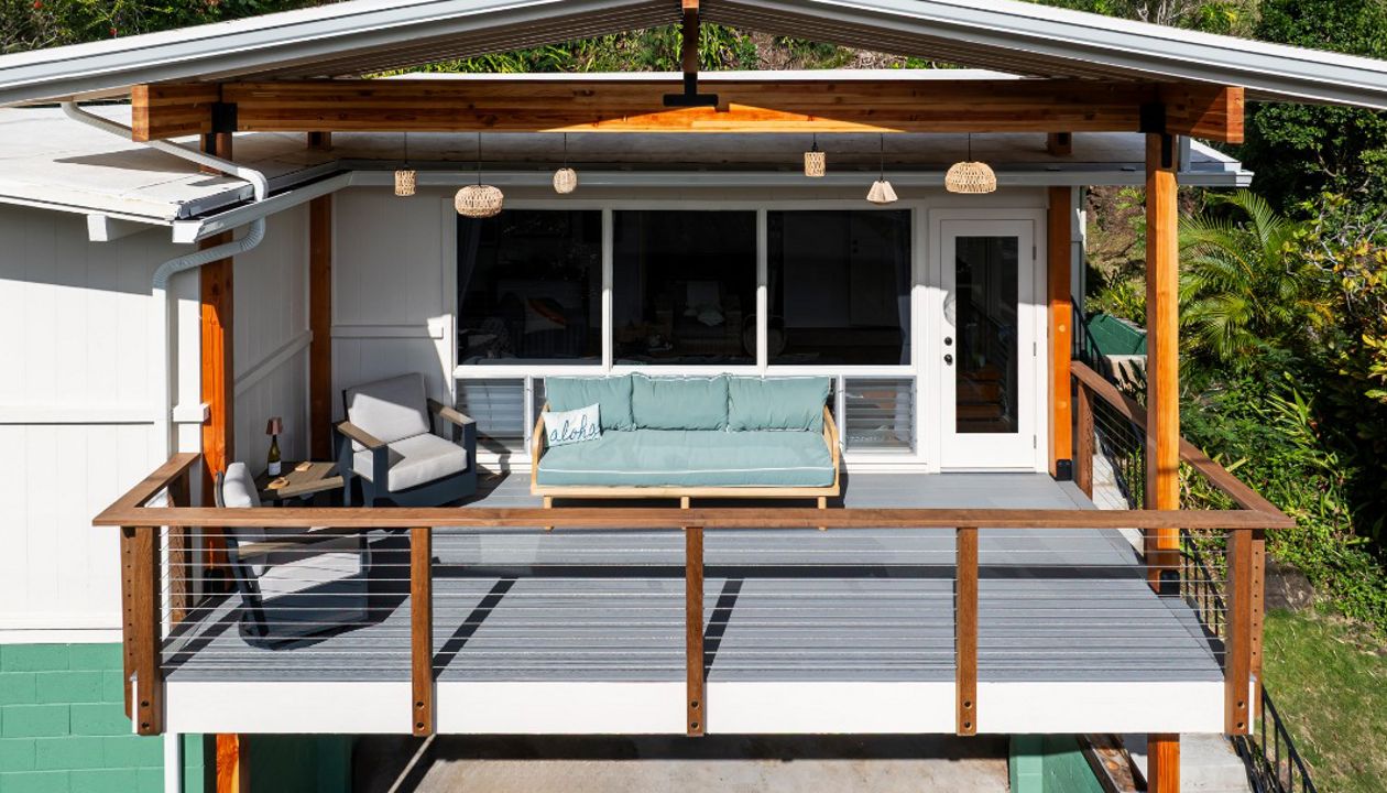 The new permitted deck in Honolulu features Pebble Grey decking and a custom cable Ipe railing for a stylish and durable design.