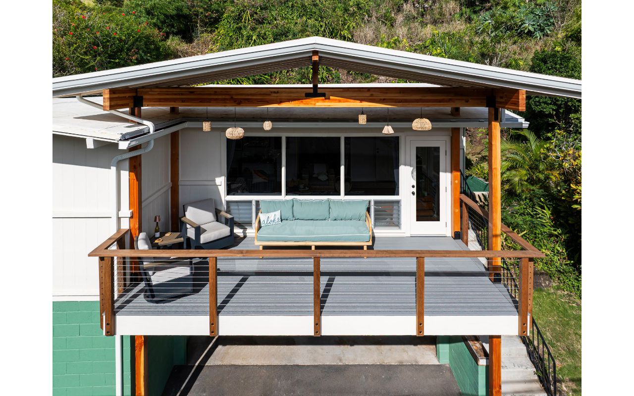 The new permitted deck in Honolulu features Pebble Grey decking and a custom cable Ipe railing for a stylish and durable design.