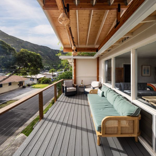 The new permitted deck in Honolulu features Pebble Grey decking and a custom cable Ipe railing for a stylish and durable design.