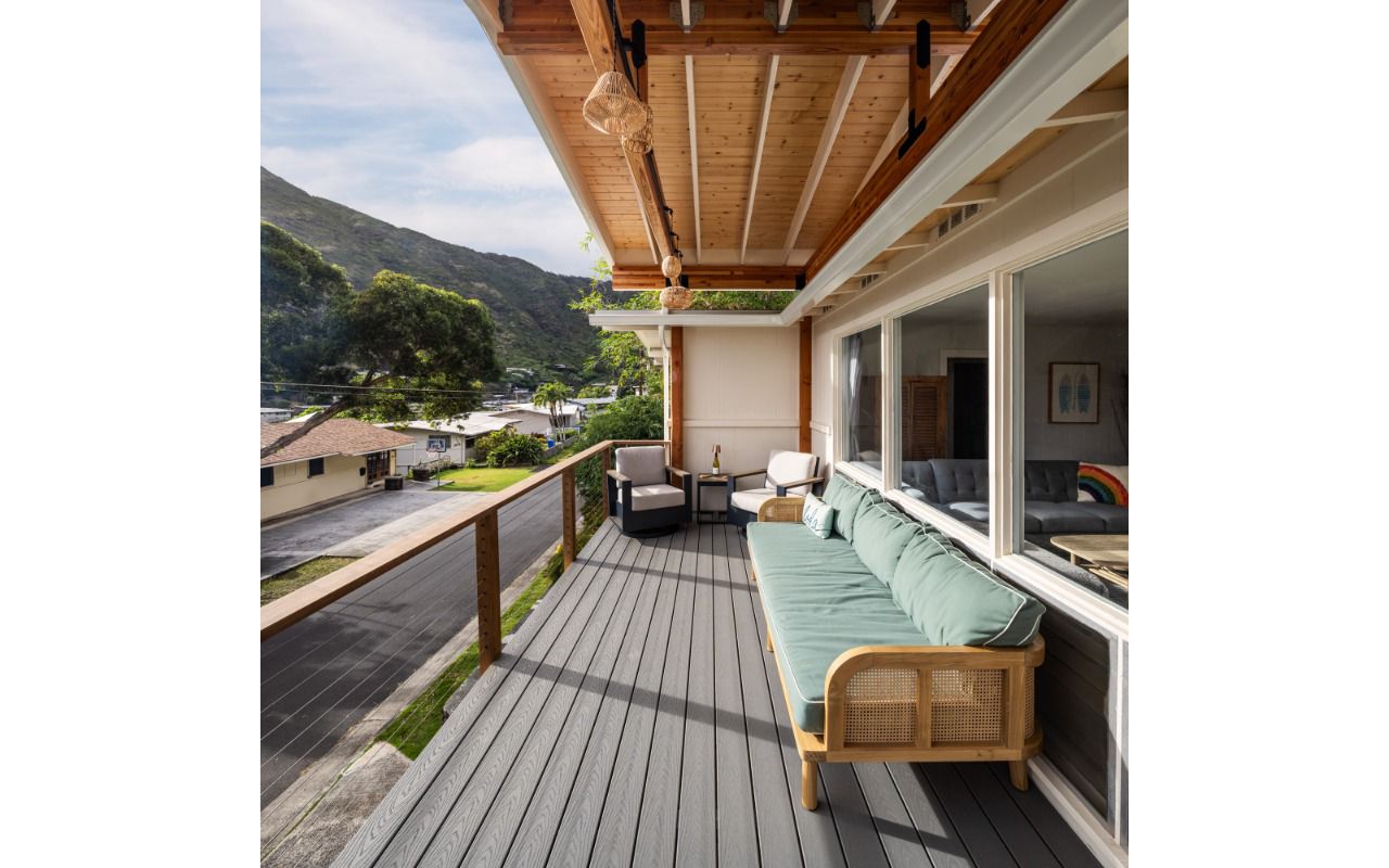 The new permitted deck in Honolulu features Pebble Grey decking and a custom cable Ipe railing for a stylish and durable design.