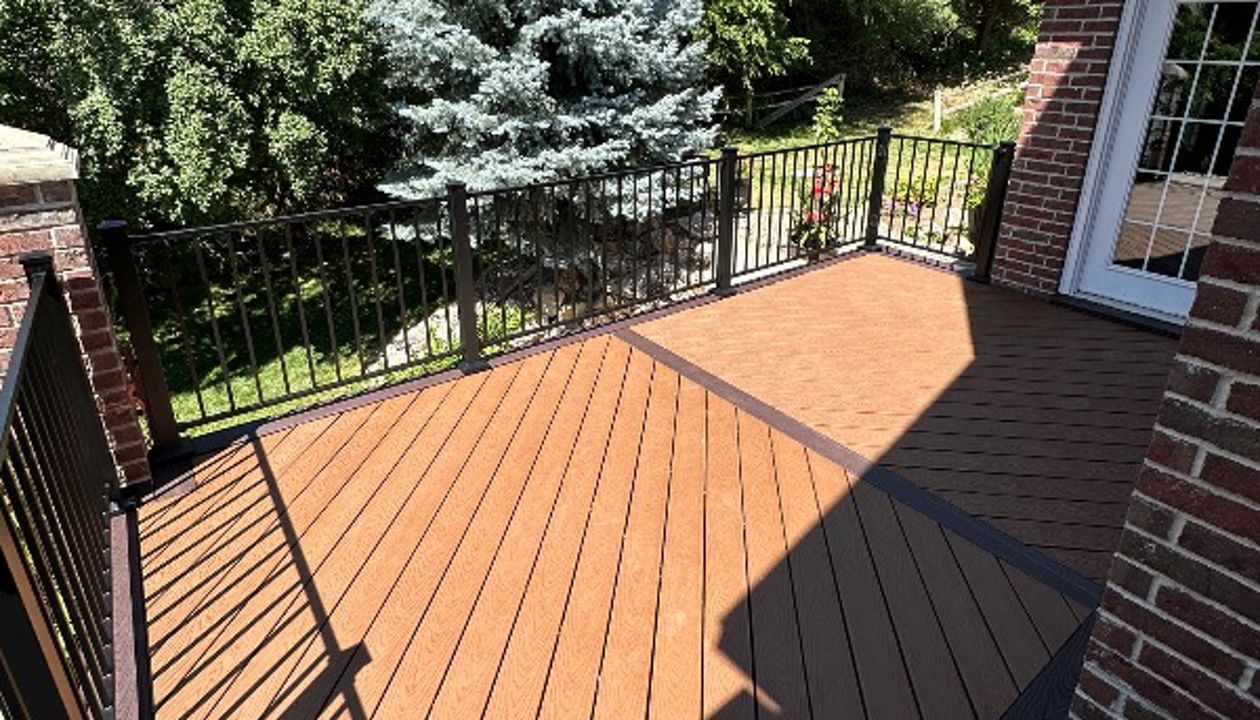 “Striking Tiki Torch decking laid at a bold 45°, framed with rich Saddle Select for contrast that commands attention — where craftsmanship meets creativity.