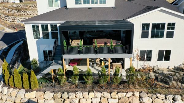 When “go big” is the plan. 🔥 16’ high • 500+ sq ft • Pebble Grey Trex Hot tub ready, fully enclosed power awning, and RainEscape keeping the lower level bone dry. This is how outdoor living levels up.