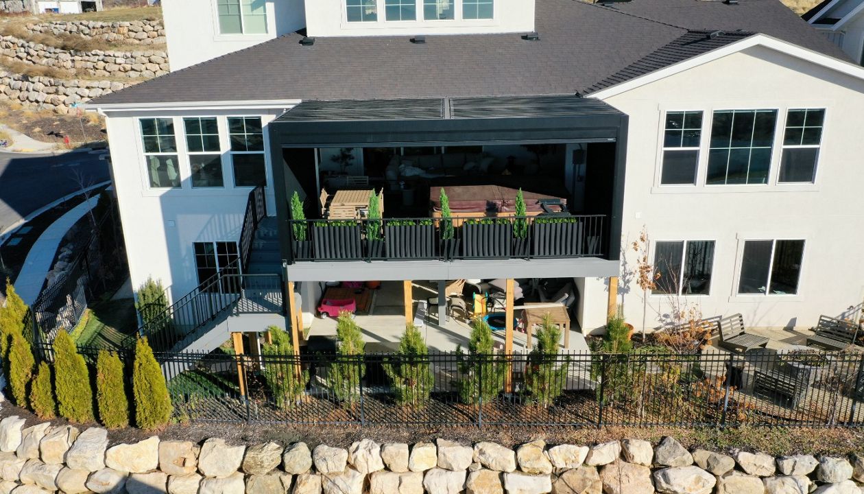 When “go big” is the plan. 🔥 16’ high • 500+ sq ft • Pebble Grey Trex Hot tub ready, fully enclosed power awning, and RainEscape keeping the lower level bone dry. This is how outdoor living levels up.