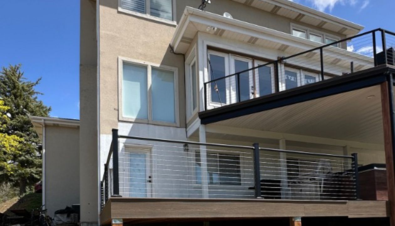 This two-story deck showcases Trex® Coastal Bluff decking paired with sleek Trex® Cable Railing — modern, durable, and built to capture the view from every level.