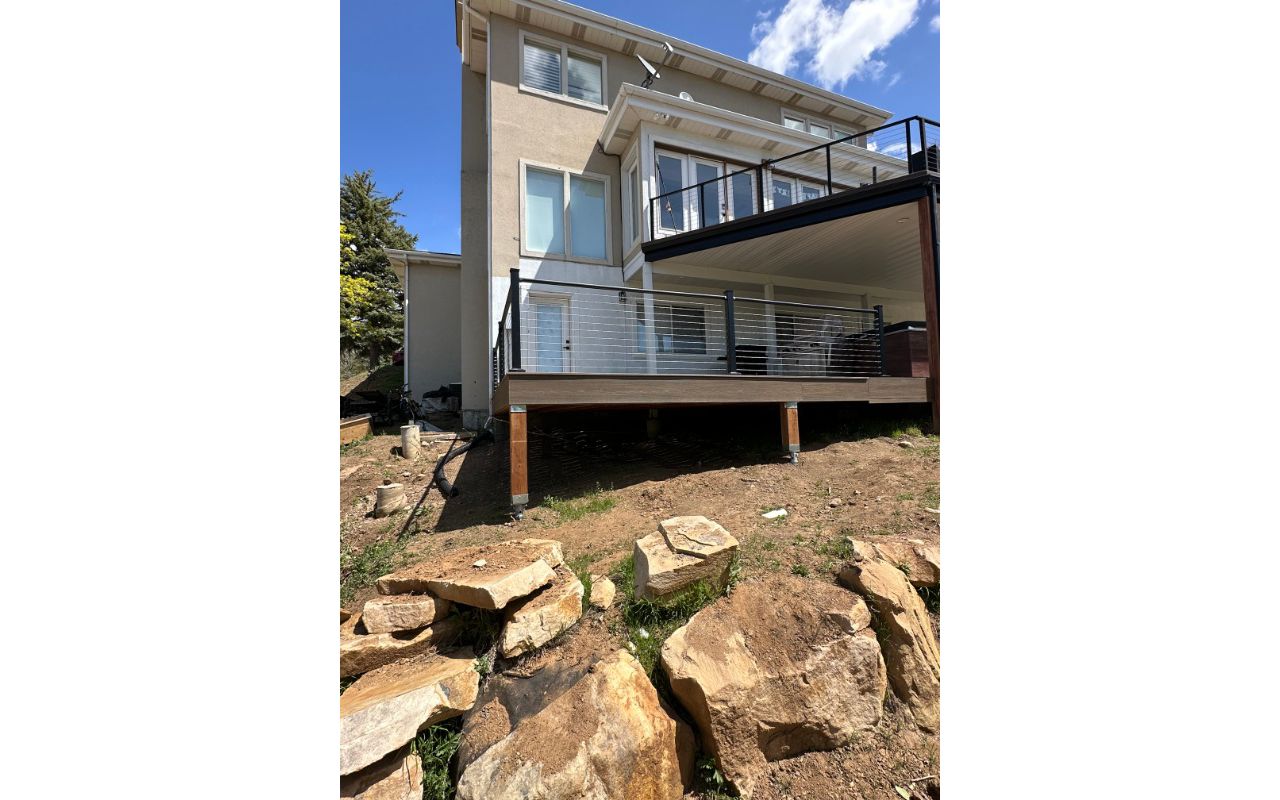 This two-story deck showcases Trex® Coastal Bluff decking paired with sleek Trex® Cable Railing — modern, durable, and built to capture the view from every level.