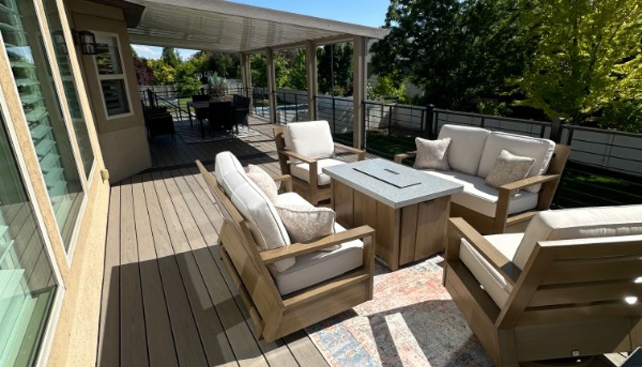 This oversized deck features Trex Biscayne decking with a Spiced Rum double picture frame, Trex Signature® railing, stair lighting, and a full wraparound awning kit. Finished with RainEscape below, it’s built for comfort, function, and serious wow factor.