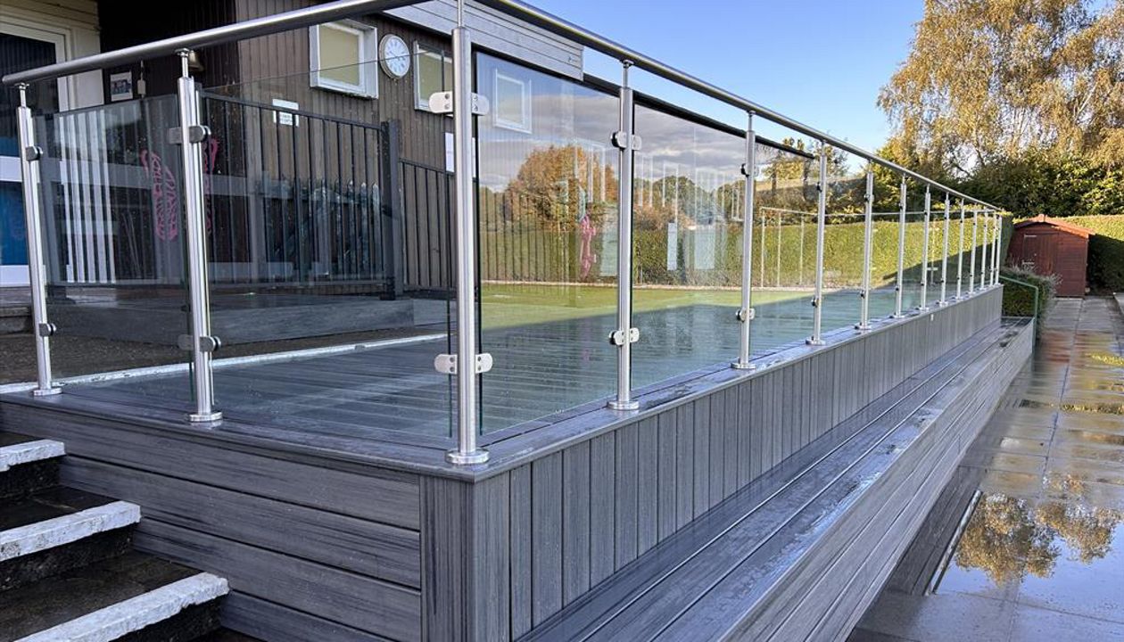 Trex Transcend Island Mist with stainless steel and glass balustrades. This was installed at a Local bowls club in Petts Wood Kent. They required a viewing area with seating to the front and wheelchair access ramp to the main building.