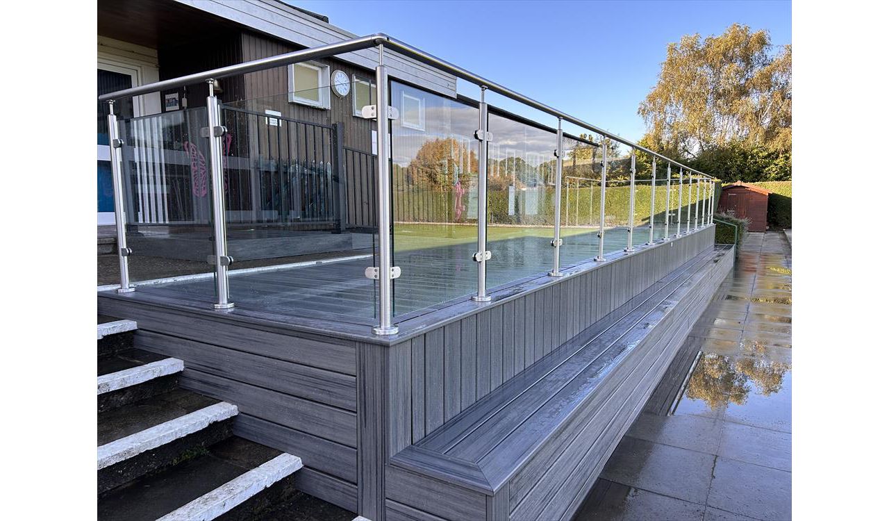 Trex Transcend Island Mist with stainless steel and glass balustrades. This was installed at a Local bowls club in Petts Wood Kent. They required a viewing area with seating to the front and wheelchair access ramp to the main building.