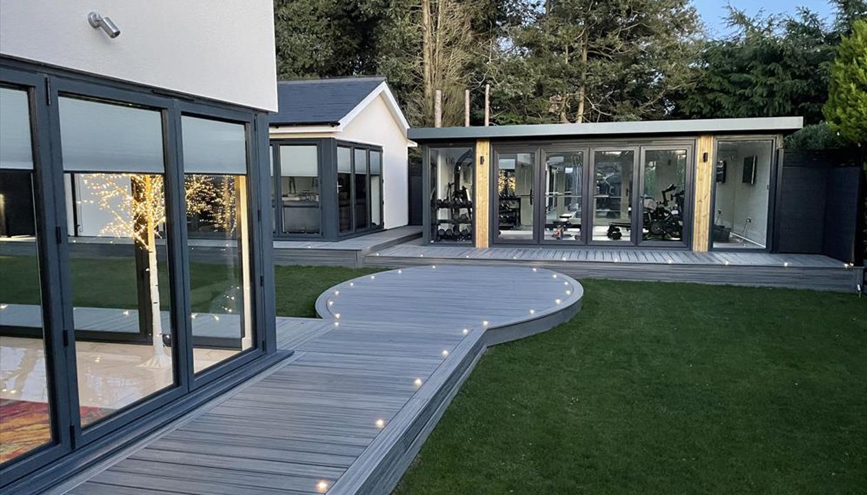 Trex Transcend Island Mist. This 200 square metre deck won us Deck of the Year in 2022, it had everything including curves, inlay, lighting and glass balustrades. The customers in Meopham, Kent were thrilled with the finished project.