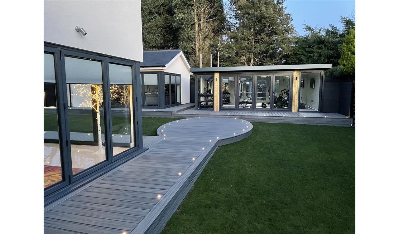 Trex Transcend Island Mist. This 200 square metre deck won us Deck of the Year in 2022, it had everything including curves, inlay, lighting and glass balustrades. The customers in Meopham, Kent were thrilled with the finished project.