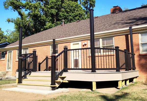 Trex Enhance Basics decking and fascia installation in tide pool color with charcoal black Enhance railing system.