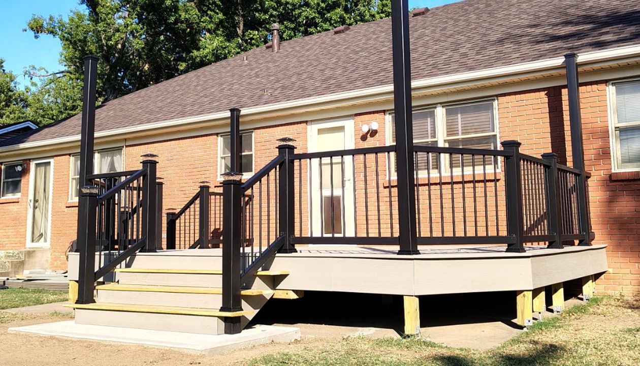 Trex Enhance Basics decking and fascia installation in tide pool color with charcoal black Enhance railing system.