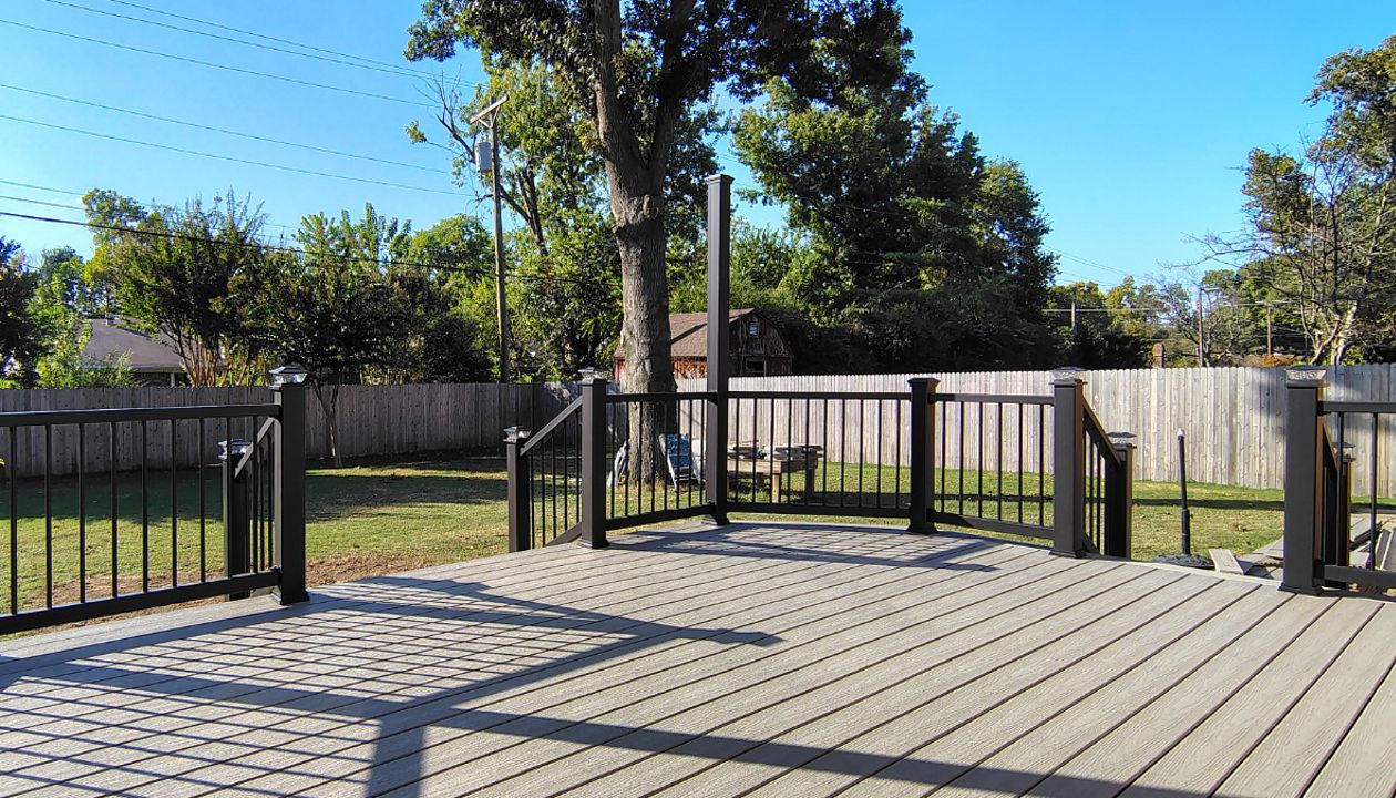 Trex Enhance Basics decking and fascia installation in tide pool color with charcoal black Enhance railing system.
