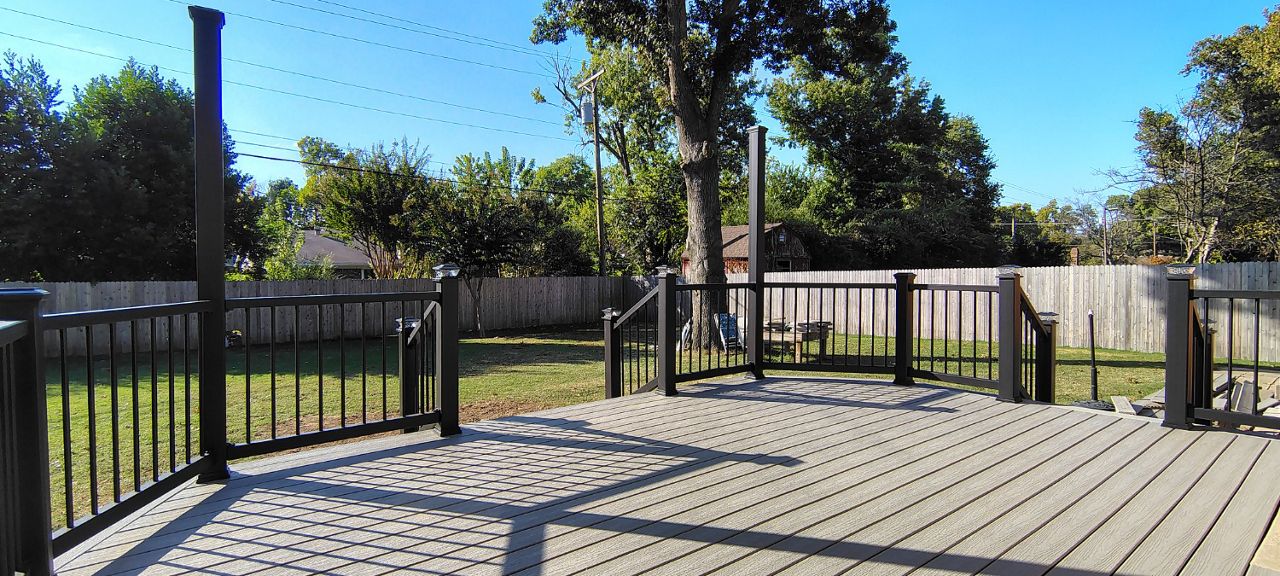Trex Enhance Basics decking and fascia installation in tide pool color with charcoal black Enhance railing system.