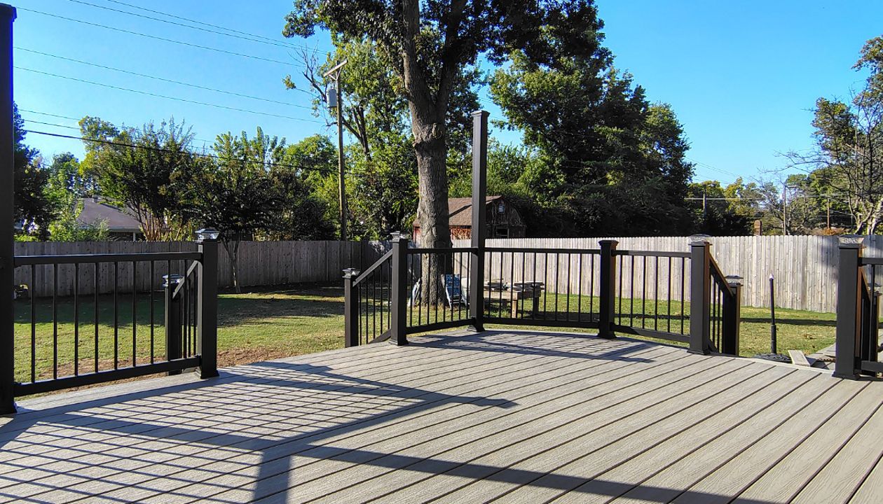 Trex Enhance Basics decking and fascia installation in tide pool color with charcoal black Enhance railing system.