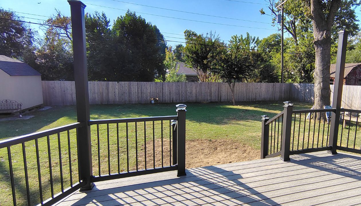 Trex Enhance Basics decking and fascia installation in tide pool color with charcoal black Enhance railing system.