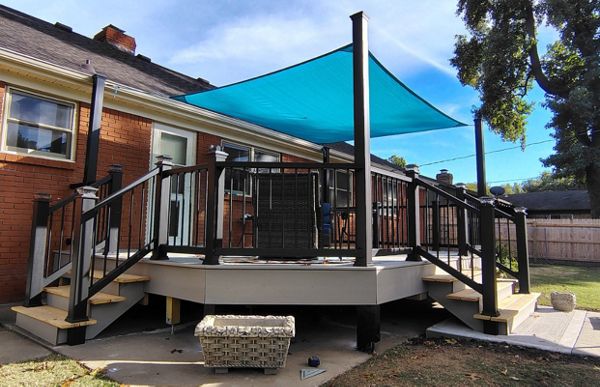 Trex Enhance Basics decking and fascia installation in tide pool color with charcoal black Enhance railing system.